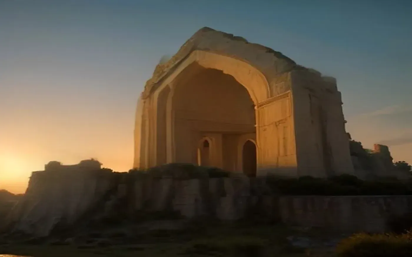Ancient hilltop fort gateway glowing at sunset