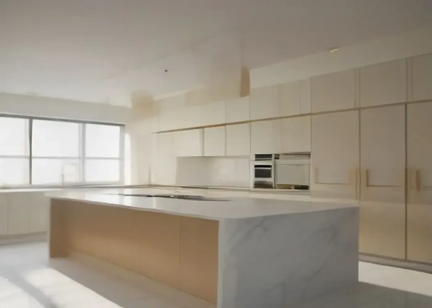 A residence kitchen with a white marble island, integrated appliances and induction hob